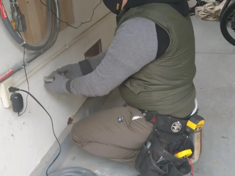 Electrician performing outlet wiring in a Du Quoin garage
